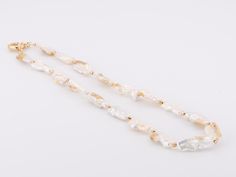 ♥ Natural Gold Infused Biwa Pearl Necklace with Sailor Clasp P1014 ♥ Pearls measure 8 x 22mm for each pearl. ♥ The item measures 18" in length. ♥ All stone(s) used are genuine, earth-mined, and guaranteed conflict free! As is with anything that is naturally occurring, our gemstones or pearls will have imperfections, e.g. inclusions in the gemstones, unevenness in the pearl nacre.♥ Free shipping in the US.♥ This is an in-stock item and ready to ship right away! Biwa Pearl Necklace, Biwa Pearls, Gold Satin, Natural Gold, The Pearl, Stunning Jewellery, Sapphire Ring, Band Rings, Pearl Necklace