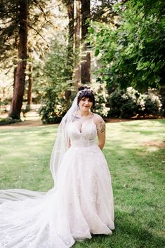 a woman in a wedding dress posing for the camera