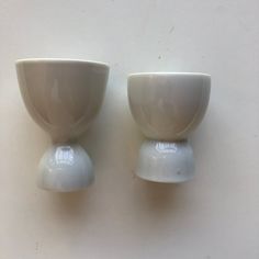 two white bowls sitting on top of each other