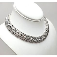 This is part of Chairish’s Costume Jewelry assortment.  1960s rhodium plated textured openwork articulated collar necklace with hook clasp. Marked "Monet" on a hangtag and "©" on the opposite side of the tag. Measures: 5 1/4 inches by 5 1/4 inches. Interior circumference on the largest setting is about 15 inches. Condition: Very good; it may have originally had a dangle at the end of the extension chain. Vintage White Gold Metal Necklace, Elegant Metal Choker With Oxidized Finish, Formal Antique Silver Metal Necklace, Formal Round Metal Choker, Retro Silver Metal Necklaces, Formal Metal Necklaces With Sterling Silver Clasp, Retro Silver Metal Necklace, Retro Silver Round Necklace, Formal Necklaces With Sterling Silver Clasp