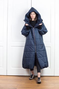 "This oversize winter jacket has elastic fabric on the sleeves. This is an extravagant model with a large hood, side pockets, long front zipper, and high collar when zipped. This urban-style jacket has a street vibe and will keep you warm for sure. * Please have in mind the model is oversize - for a fitted look please go a size down. Review from our customer: \"This coat is amazing! As soon as I put it on and stepped outside, I received so many compliments. Everyone said I looked so cozy...lol M Puffer Jacket Outfits, Trendy Winter Coats, Cyberpunk Jacket, Goth Jacket, Steampunk Jacket, Long Down Jacket, Long Down Coat, Asymmetric Jacket, Long Coat Women