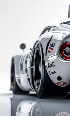 a white sports car with the american flag painted on it's side and wheels