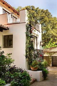 a house with plants growing on the side of it