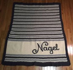 a crocheted rug with the word navel on it in black and white