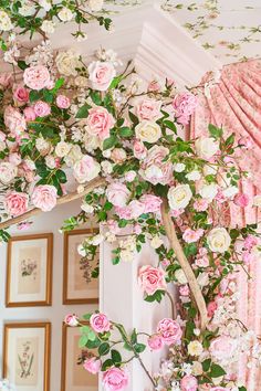 pink and white flowers are growing on the wall