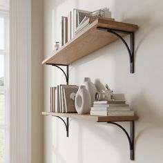 two wooden shelves with books and vases on them