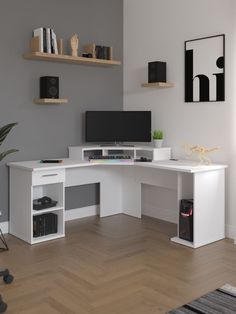 a white desk with two computer monitors on top of it and shelves above the desk