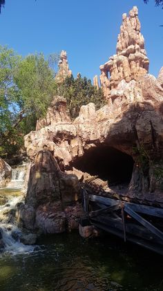 there is a small waterfall in the middle of this rock formation that looks like it's coming out of a cave