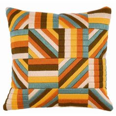 an orange, brown and blue striped pillow on a white background with the same pattern