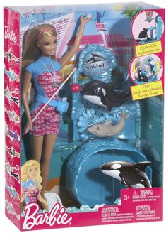 the barbie doll is playing with her dolphin and whale toy in its box, it's not too big for her to fit