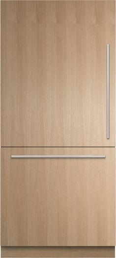 a wooden refrigerator freezer sitting on top of a white counter next to a wall