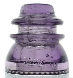 a purple vase sitting on top of a white table