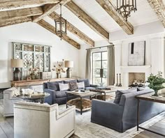 a living room filled with lots of furniture next to a fire place in a house