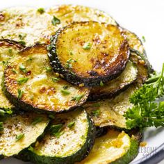 grilled zucchini on a plate with parsley