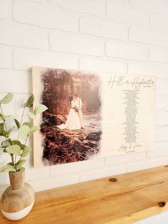 a wooden shelf with a vase on top of it next to a sign that says, he is his shepherd