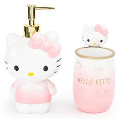 a hello kitty soap dispenser next to a pink cup and toothbrush holder