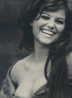 black and white photograph of a woman smiling with long hair in front of her face