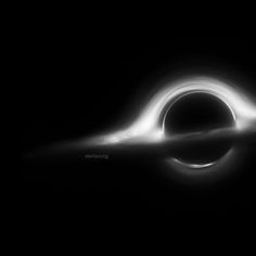 a black and white image of a ring in the sky with light coming from it