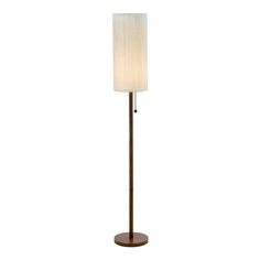 a floor lamp with a white shade on the top and a brown base, in front of a white background