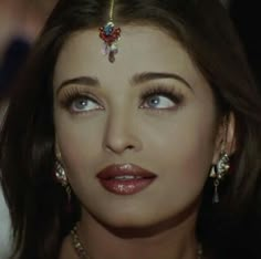 a close up of a woman with jewelry on her head