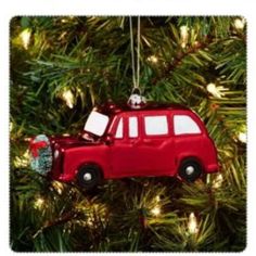 a red car ornament hanging from a christmas tree