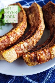 grilled steaks on a plate with parsley in the background and air fryer pork belly