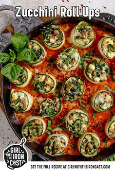 zucchini rolls with spinach and cheese in a skillet on the table