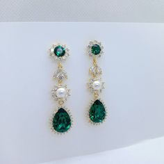 Material: Swarovski emerald crystals(not real or simulated emerald), clear cubic zirconia paved findings, plated brass findings, sterling silver ear posts. Size: Full length approx 5cm, 1.4cm wide. Teardrop dangles are 1.6cm*1.4cm. Metal Color: Available in Rose Gold, Yellow Gold and White Gold(silver tone). Please choose a color when you place an order. Crystal Color: Emerald Green. Available in many other colors. please contact us if you need different colors. Necklace earrings set: https://ww Emerald And Pearl Earrings, Green Chandelier, Green Chandeliers, Emerald Earrings, Earrings White, Swarovski Earrings, Emerald Jewelry, Swarovski Jewelry, Simple Earrings