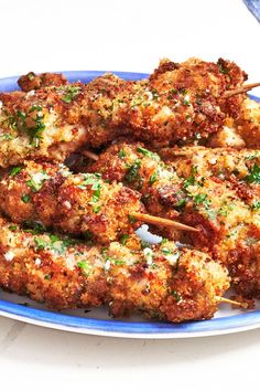 chicken skewers on a blue plate with toothpicks