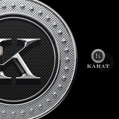 the letter k is inscribed in silver on a black background