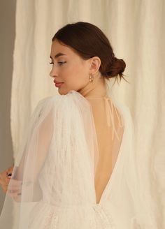 the back of a woman wearing a white wedding dress