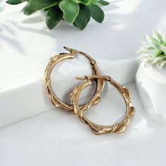 Handcrafted leaf hoop earrings in 14k or 18k solid gold. These floral branch hoops are a great anniversary gift or Valentine's Day gift for that special someone. A beautiful everyday accessory to add to your collection.  Each design was created in wax to mimic a flowing combination of 5 leaves, twigs and vines. By choosing our handcrafted earrings, you're not only treating yourself or a loved one to a piece of wearable art, but you're also supporting authentic craftsmanship. Add these enchanting hoops to your collection Our Refined Gold is not only a statement of opulence but also a pledge to compassion--ensuring that your beautiful accessory is entirely cruelty-free. Dimensions: Outside dimensions: Approx. 22.86mm/1 inch Setting: #097 dvjewelrydesigns.com Visit Our Blog http://www.dawnver Nature-inspired Round Hoop Earrings For Gift, Nature-inspired Hoop Earrings As Gift, Nickel-free Gold Hoop Earrings Fine Jewelry, Nature-inspired Gold Hoop Earrings For Pierced Ears, Gold Nickel-free Hoop Earrings Fine Jewelry, Gold Nickel-free Fine Jewelry Hoop Earrings, Gold Nature-inspired Hoop Earrings, Nature-inspired Gold Hoop Earrings, Nature-inspired Small Hoop Earrings For Gifts