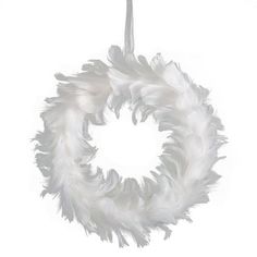 a white feather wreath ornament hanging from a string