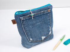 "Keep everything organized with this versatile zipper pouch. It can be used to store cosmetics, craft supplies, hair accessories, makeup and more. Make from a recycled blue jean pocket. Approximate size: 7\"W x 7\"H and 2\" gusset at the base. *Listing is for one pouch, other items are not included. Computer monitor colours vary, the actual colour may be slightly different. Made in a smoke free home studio.  SHIPPING: if you are purchasing this item with a larger item, shipping is free or at a reduced cost for multiple small items. Message me for details." Unique Stockings, Jean Pockets, Lap Quilt, Toiletry Storage, Blue Jean, Computer Monitor, Zipper Pouch, Pencil Case, Cosmetic Bag