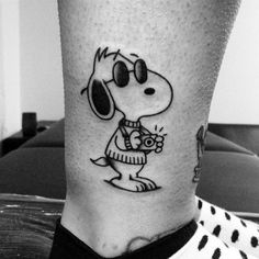 a black and white photo of a person's leg with a cartoon character on it