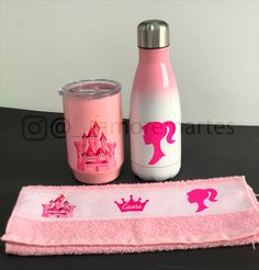 a pink princess bottle next to a pink towel on a table