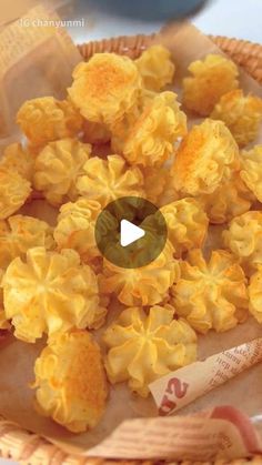 a basket filled with yellow flowers on top of a white table next to a measuring tape