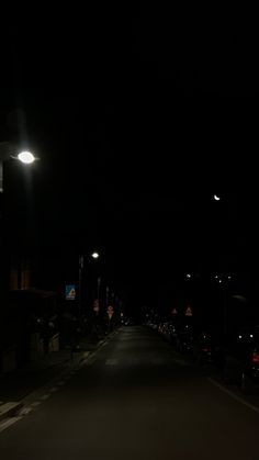 an empty street at night with lights on and no one in the dark or out