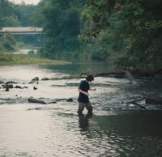 a man standing in the middle of a river