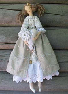 a doll is hanging on the side of a wooden wall