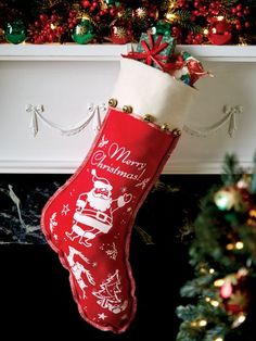 a red christmas stocking hanging from a mantel