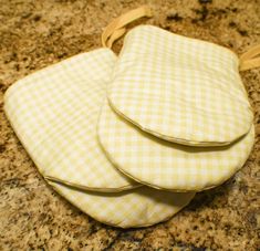 three pieces of cloth sitting on top of a counter