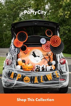 the trunk of a car decorated for halloween with decorations and words that read, shop this collection