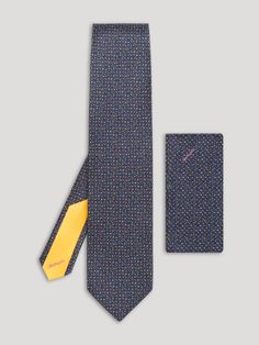 Navy blue floral tie with pink and yellow floral details and matching handkerchief. Designer Semi-formal Suit And Tie Accessories, Designer Suit And Tie Accessories For Semi-formal, Multicolor Ties With Pocket Square, Multicolor Tie With Pocket Square, Formal Silk Suit Accessories With Pocket Square, Formal Silk Suit And Tie Accessories With Pocket Square, Silk Neckwear With Pocket Square For Formal Occasions, Elegant Multicolor Pocket Square For Formal Occasions, Elegant Multicolor Pocket Square For Formal Wear