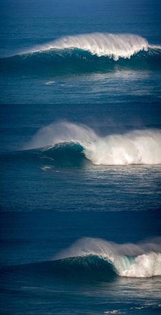 three large waves in the ocean near one another