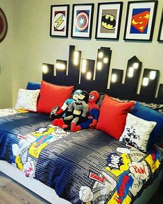 a bed room with a neatly made bed and pictures on the wall above it at night