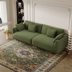 a green couch sitting on top of a rug in a living room