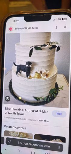 a cell phone with an image of a wedding cake and a black dog on it