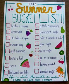 a summer bucket list with fruits and vegetables on it sitting on top of a wooden table