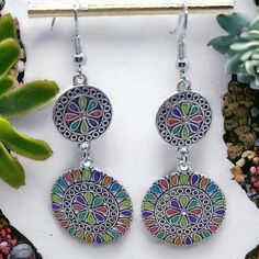 the earrings are decorated with multicolored designs